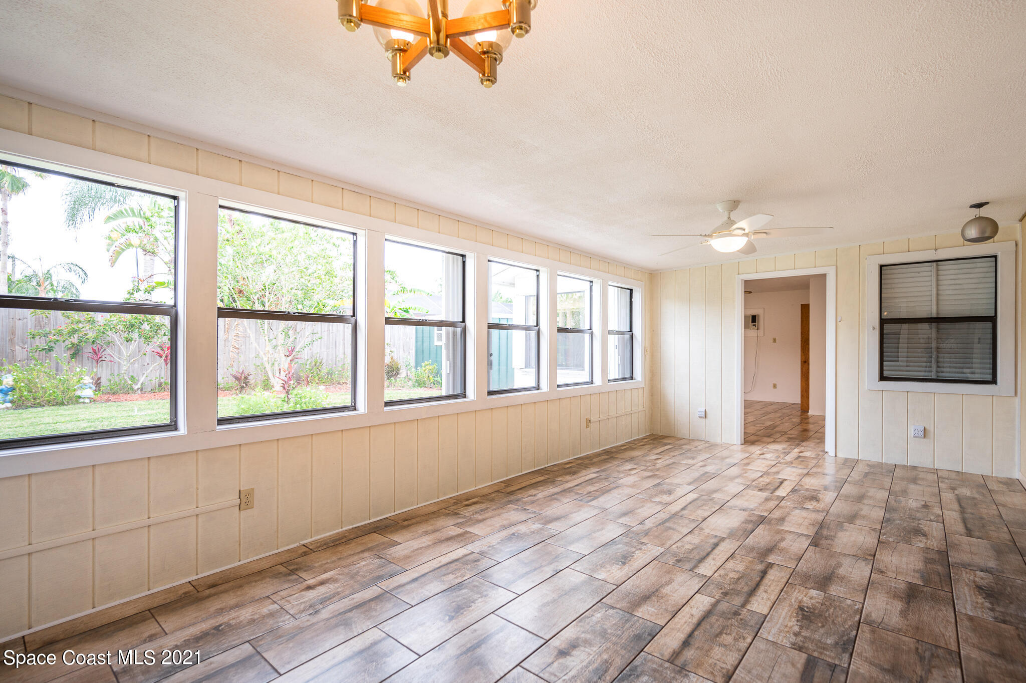 1100 Madrid Road Rockledge, FL 32955 - Photo 14 of 29 a view of an empty room with a window and a kitchen