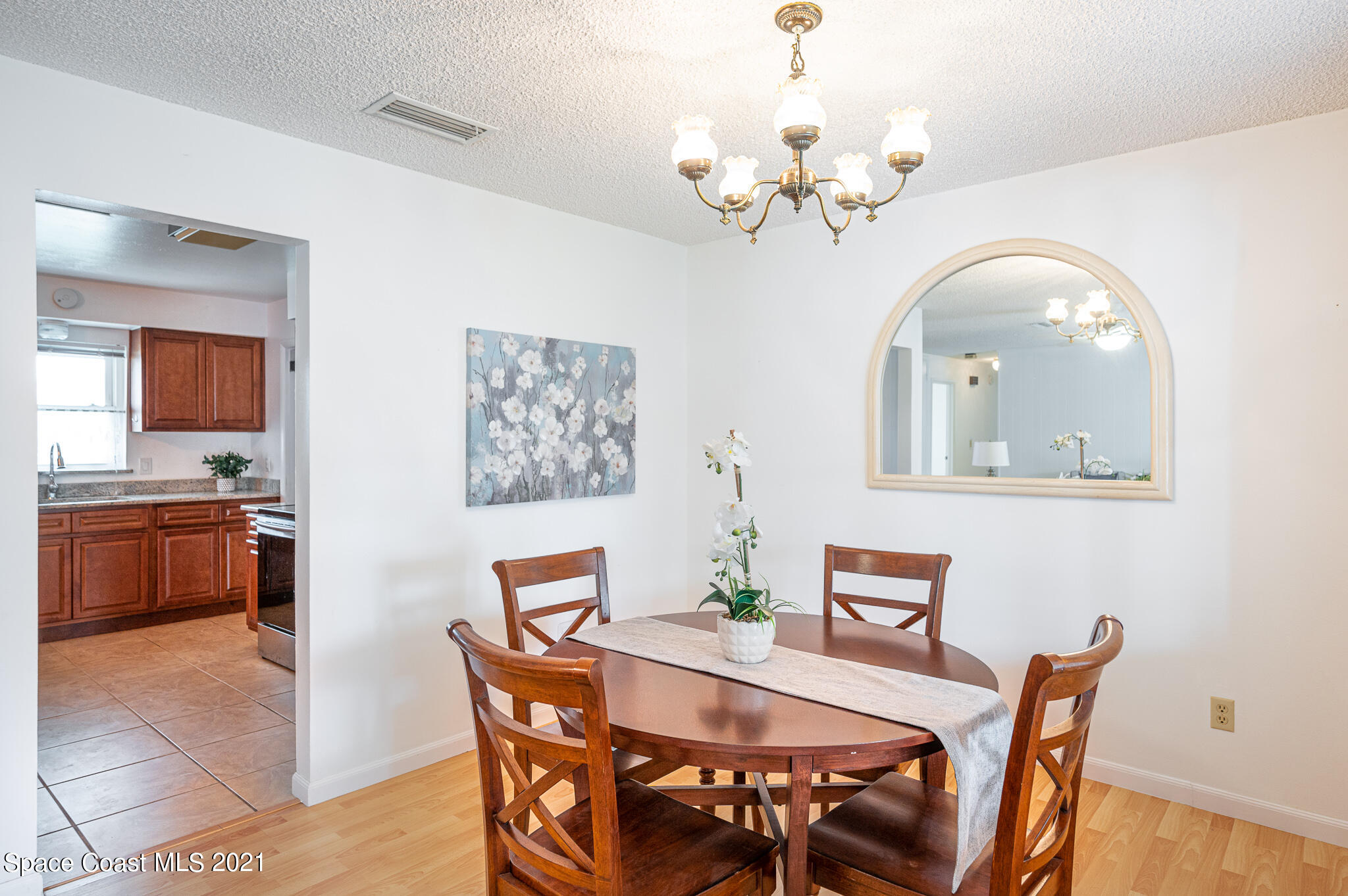 1100 Madrid Road Rockledge, FL 32955 - Photo 8 of 29 a view of a dining room with furniture and a chandelier