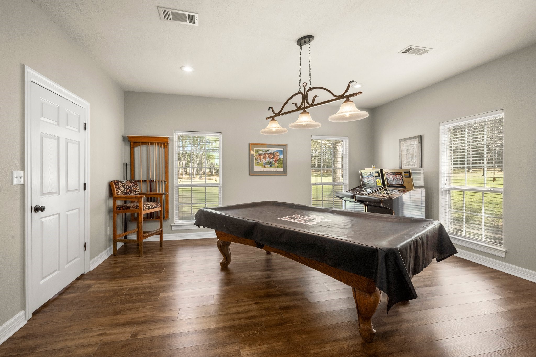 825 Walding Road Livingston, TX 77351 - Photo 17 of 50 a dining room with wooden floor a chandelier a wooden table and chairs