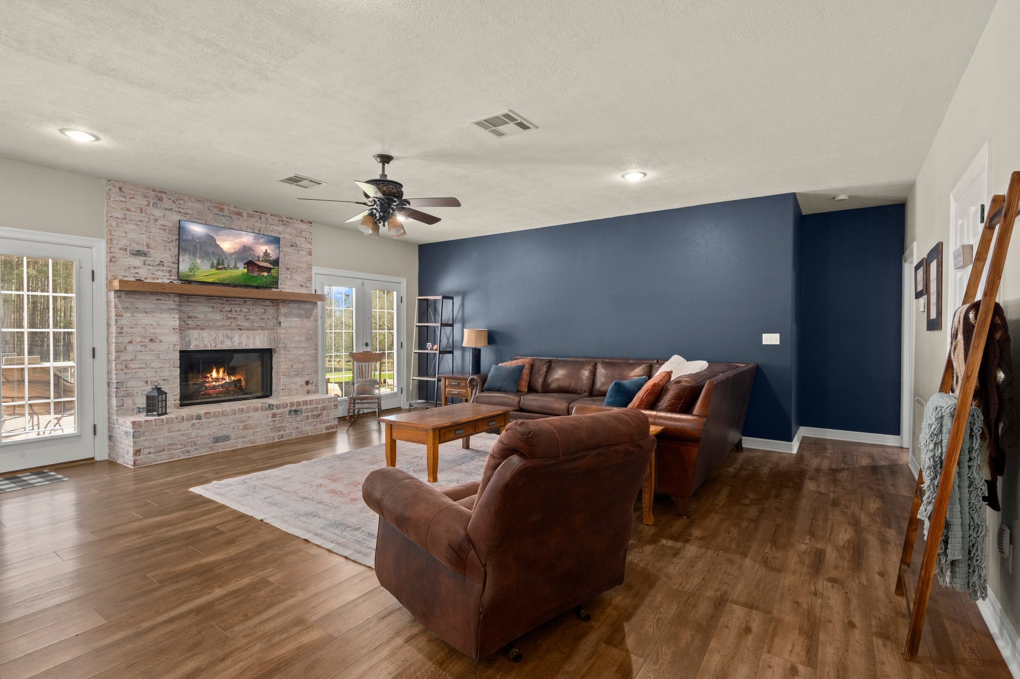 825 Walding Road Livingston, TX 77351 - Photo 20 of 50 a living room with furniture a fireplace and a chandelier