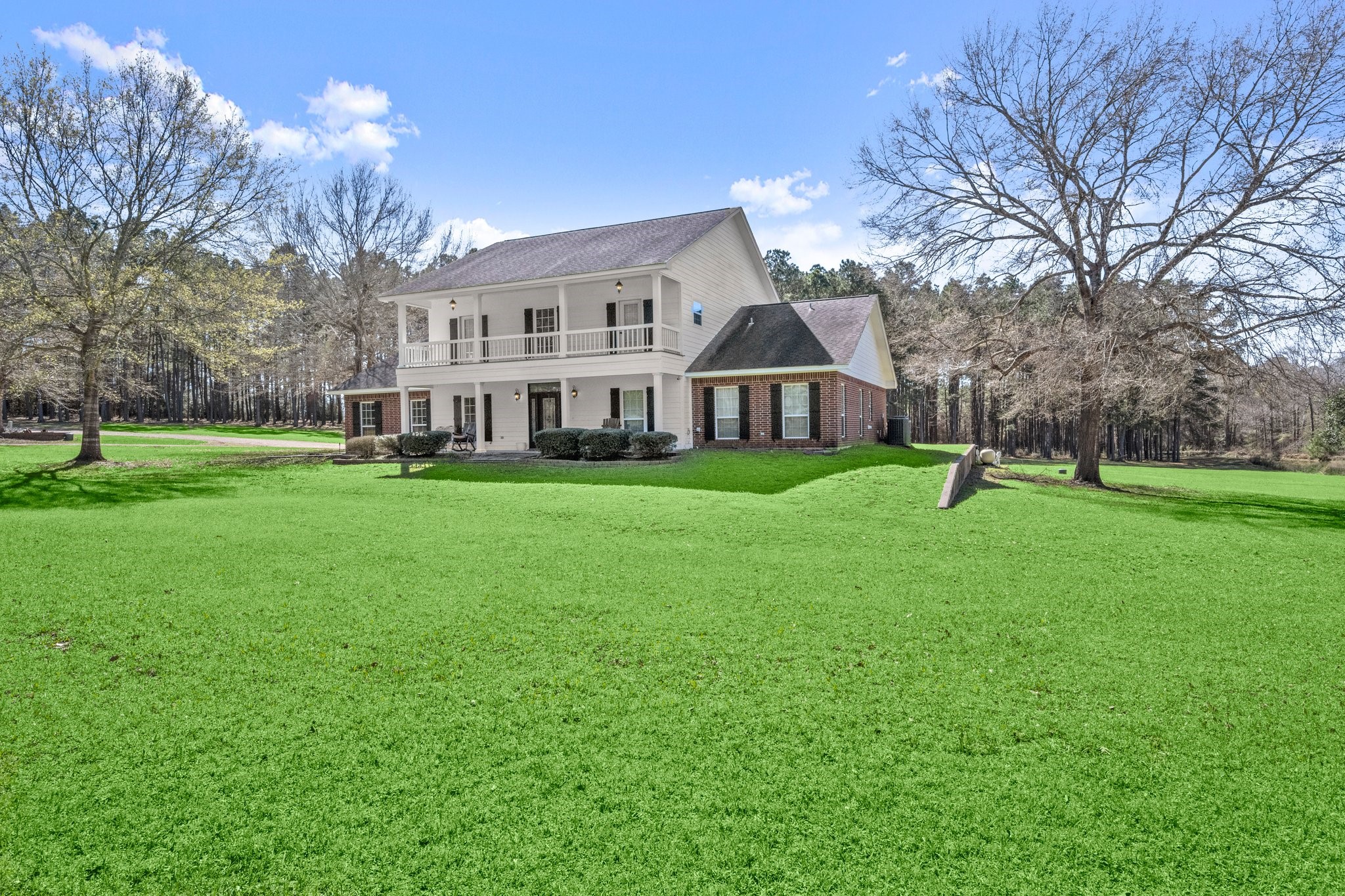 825 Walding Road Livingston, TX 77351 - Photo 2 of 50 a front view of a house with garden and trees