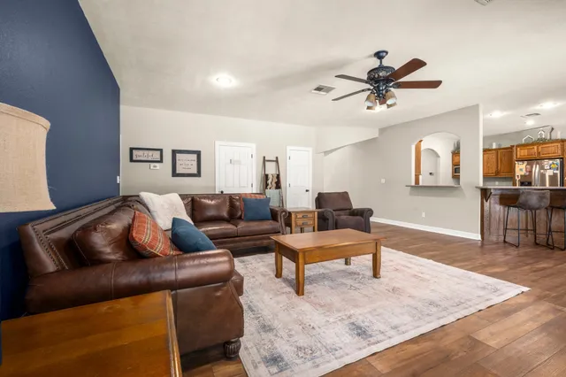 a living room with furniture and a fireplace
