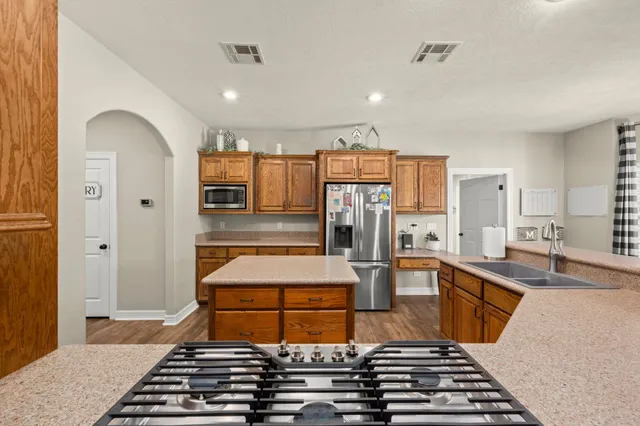 a room with furniture a flat screen tv and large mirror