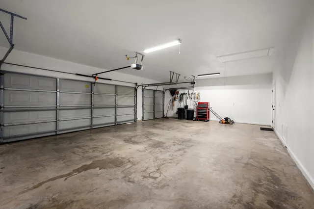 an empty room with wooden floor and entryway