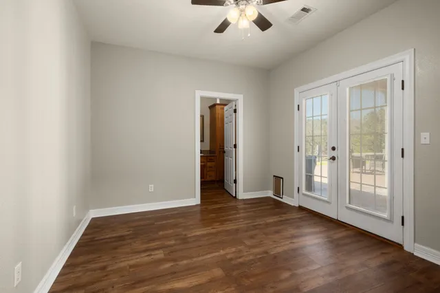 a bathroom with a granite countertop sink a mirror and shower