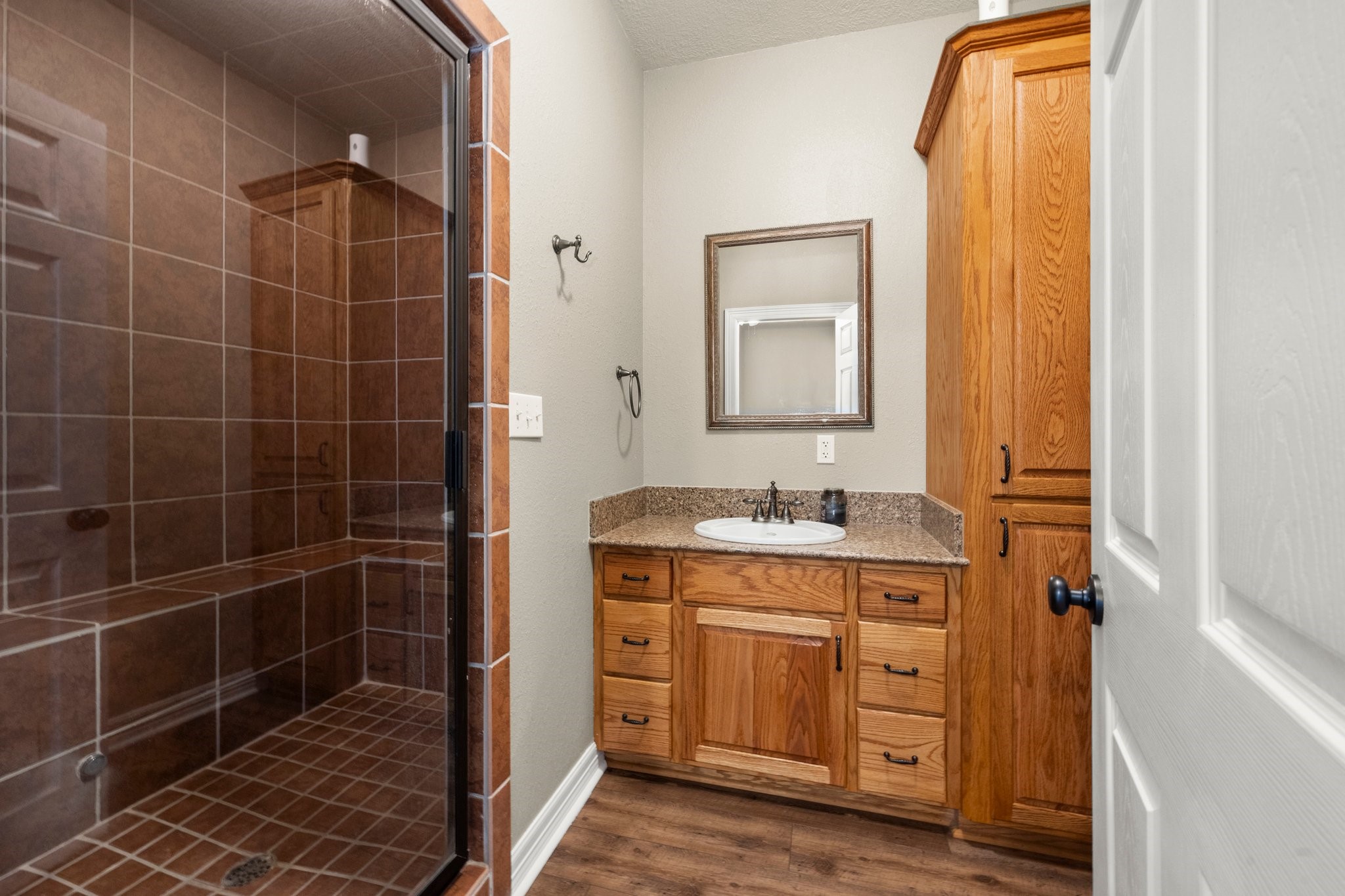 825 Walding Road Livingston, TX 77351 - Photo 33 of 50 a bathroom with a granite countertop sink a mirror and a shower