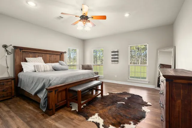 a bedroom with furniture and wooden floor