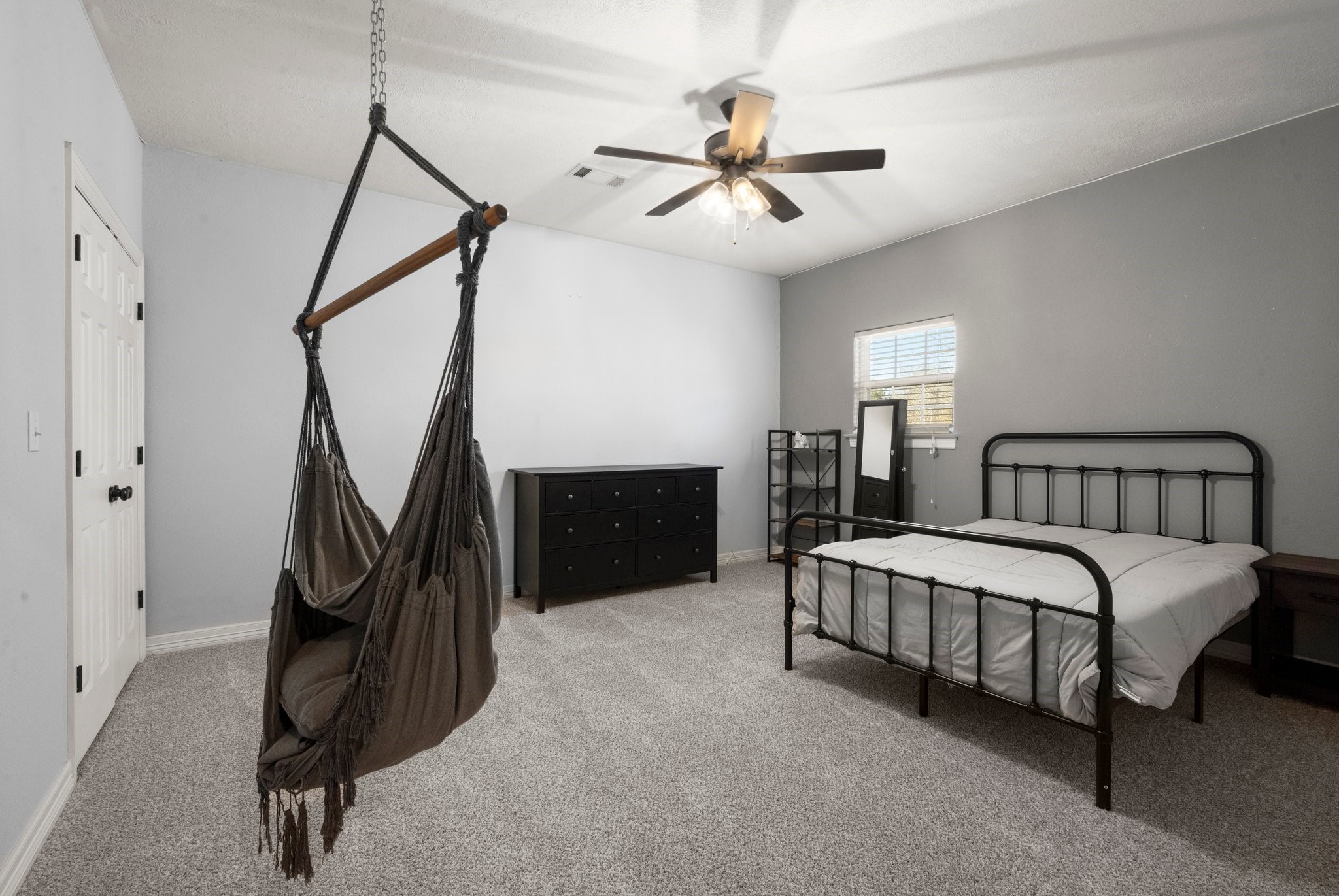 825 Walding Road Livingston, TX 77351 - Photo 45 of 50 a spacious bedroom with a bed and a chandelier