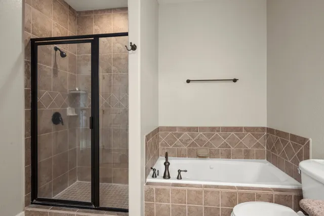 a spacious bedroom with a bed and a chandelier