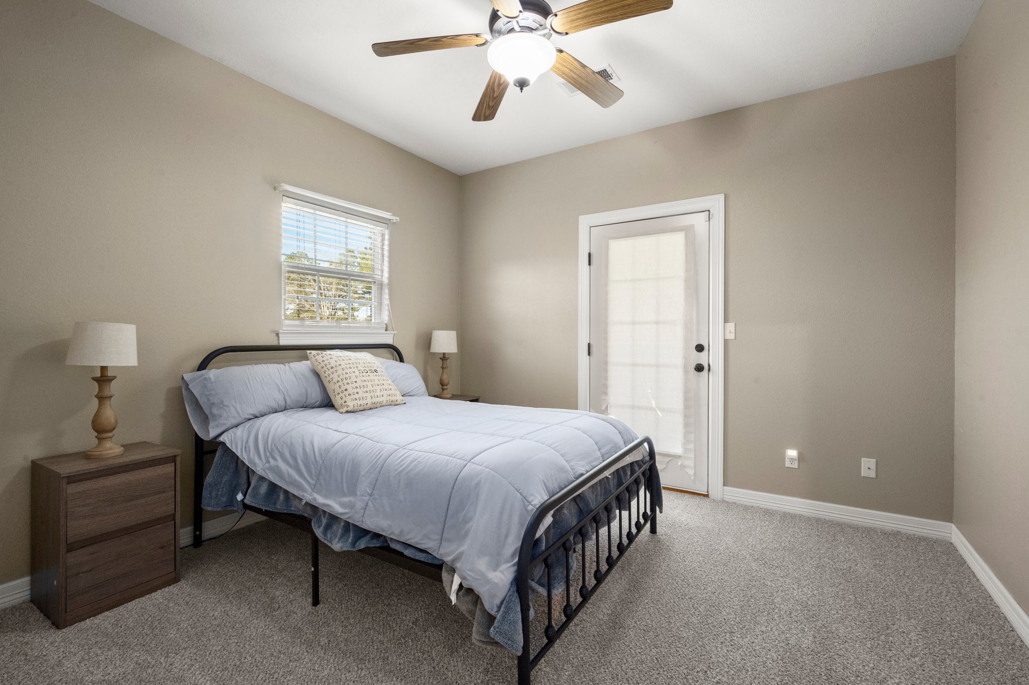 825 Walding Road Livingston, TX 77351 - Photo 48 of 50 a spacious bedroom with a bed and a chandelier