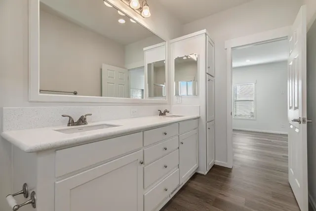 a bathroom with a granite countertop toilet sink and mirror