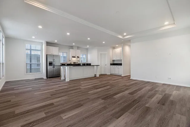 a view of a kitchen with wooden floor and a kitchen