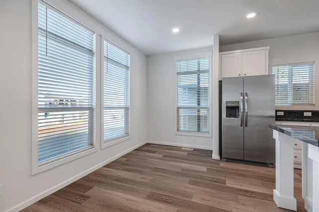a kitchen with stainless steel appliances granite countertop a stove a sink and a refrigerator