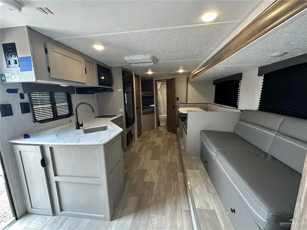 a kitchen with stainless steel appliances kitchen island granite countertop a sink and cabinets