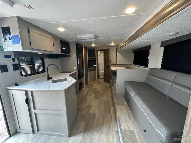 a kitchen with stainless steel appliances kitchen island granite countertop a sink and cabinets
