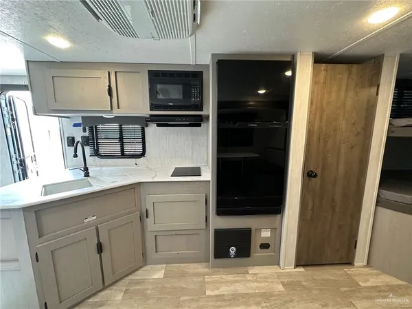 a kitchen with cabinets and window