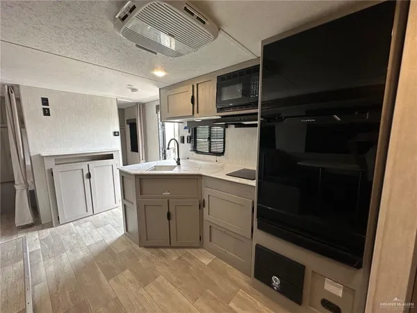 a kitchen with kitchen island cabinets and stainless steel appliances