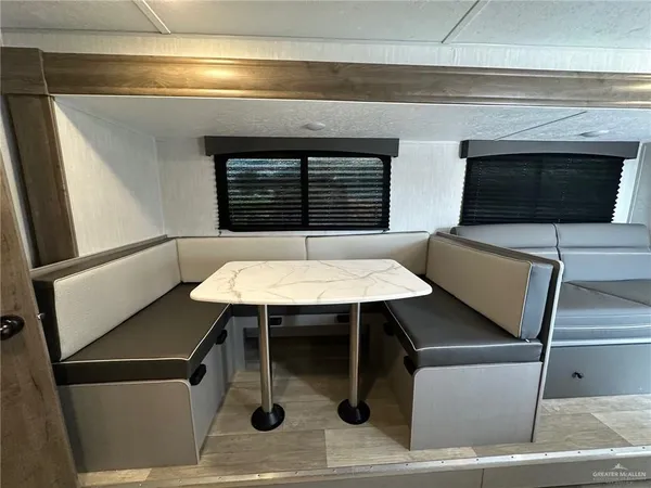 a bathroom with a sink a toilet a mirror and shower