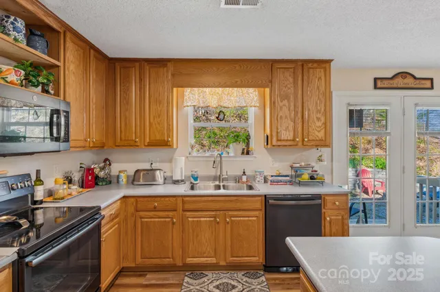 a kitchen with a sink stove and cabinets