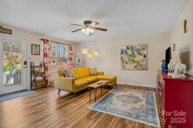 a living room with furniture and wooden floor