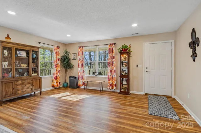 a view of a livingroom with furniture hardwood floor and a ceiling fan