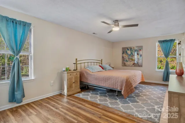 a spacious bedroom with a bed and a window