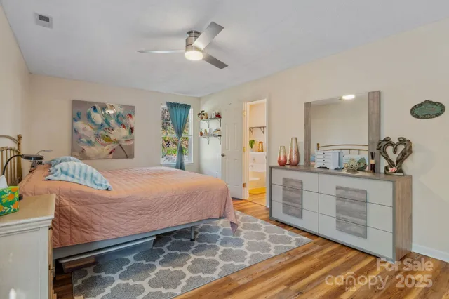 a bedroom with a bed and ceiling fan