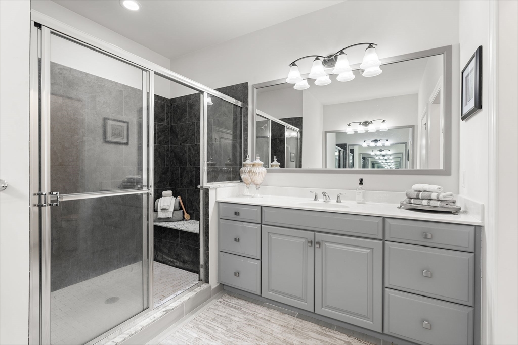 2 Hummingbird Way, Unit 1 Methuen, MA 01844 - Photo 18 of 42 a bathroom with a shower sink and mirror