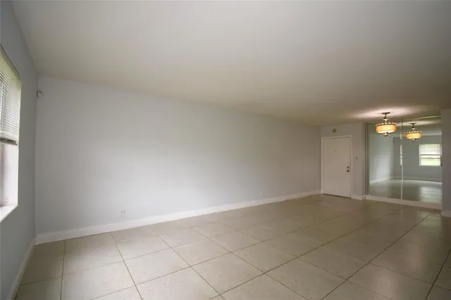 an empty room with entrance and windows