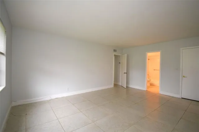 a view of an empty room and a window