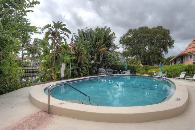 a view of a swimming pool with a yard