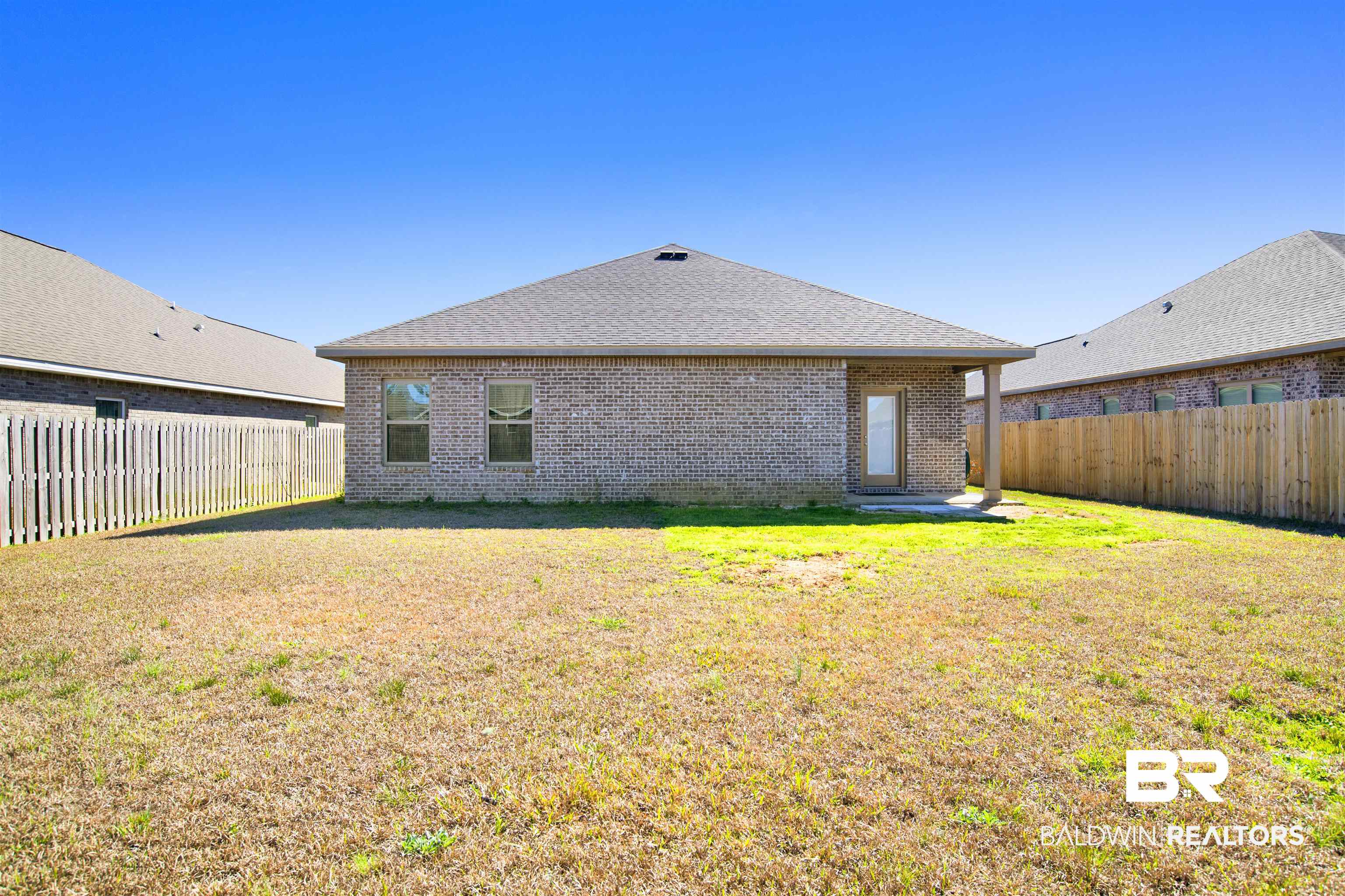 1174 Pheasant Circle Foley, AL 36535 - Photo 27 of 29 Back of house with a patio, brick siding, a fenced backyard, and roof with shingles
