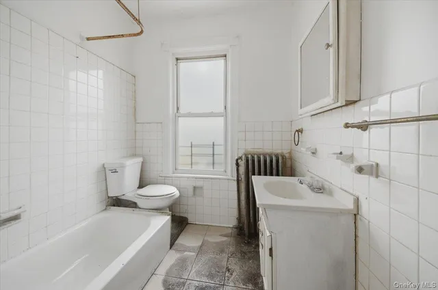 a bathroom with a bathtub sink and toilet
