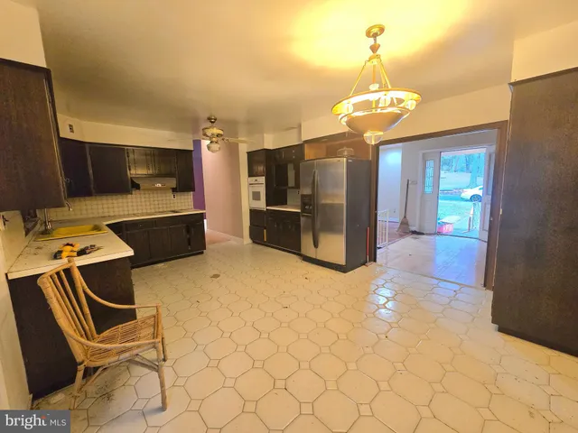 a view of a kitchen with a sink and a refrigerator