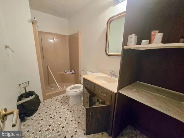 a bathroom with a sink toilet and a mirror