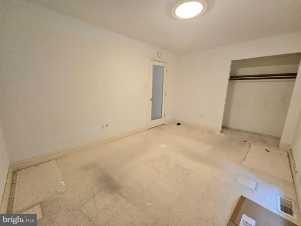 a view of an empty room with windows
