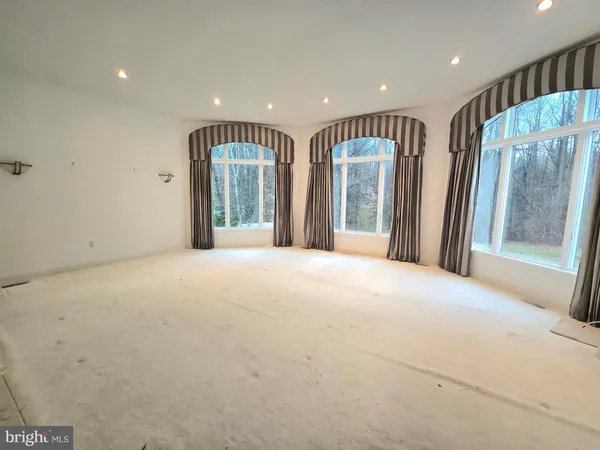 a view of an empty room with glass door