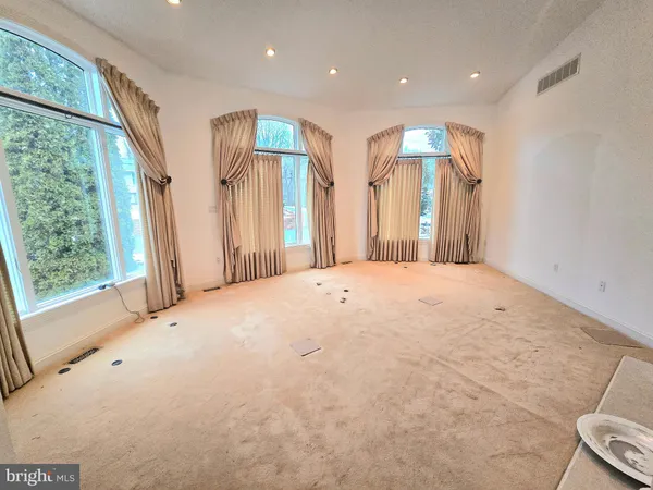 a view of a livingroom with wooden floor and a window
