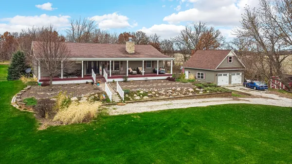 a view of a house with a yard patio and swimming pool