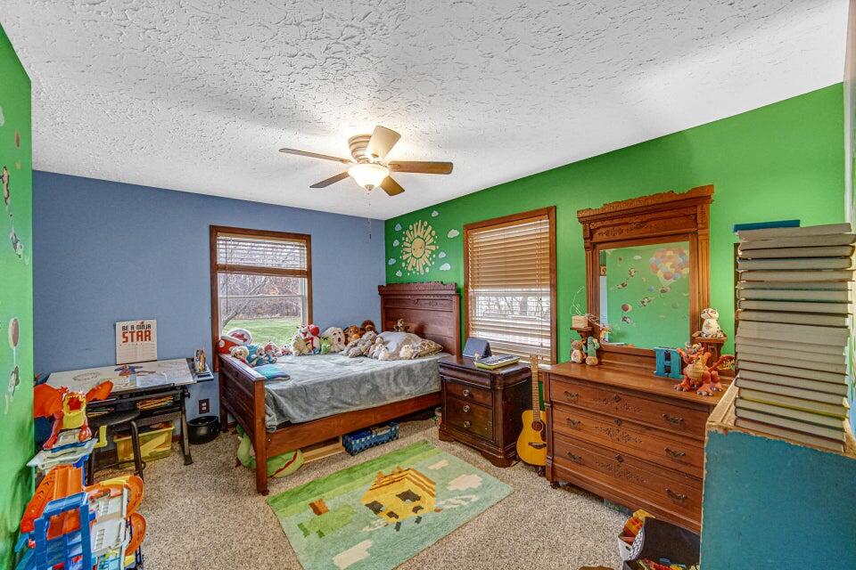 7960 East 173rd Avenue Hebron, IN 46341 - Photo 13 of 36 a bedroom with furniture and a large window