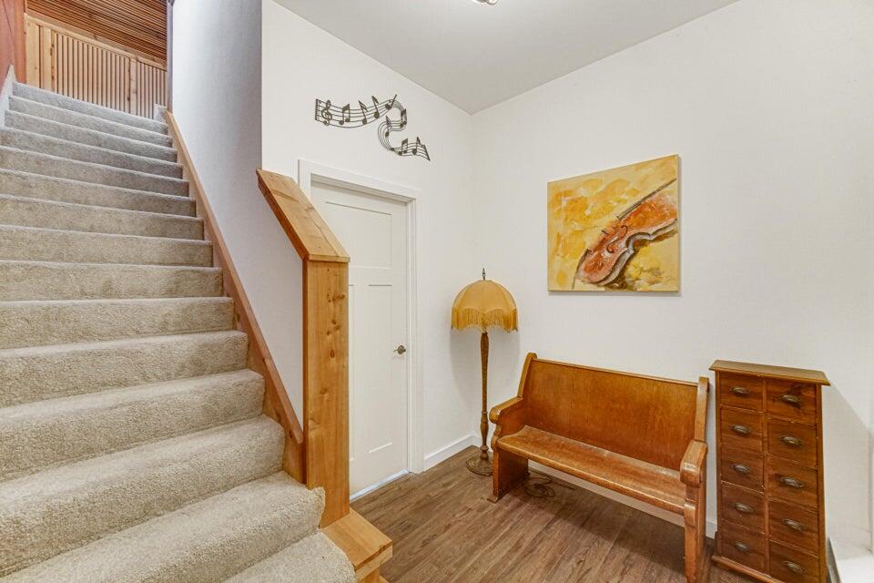 7960 East 173rd Avenue Hebron, IN 46341 - Photo 22 of 36 a view of staircase with white walls and a painting on the wall