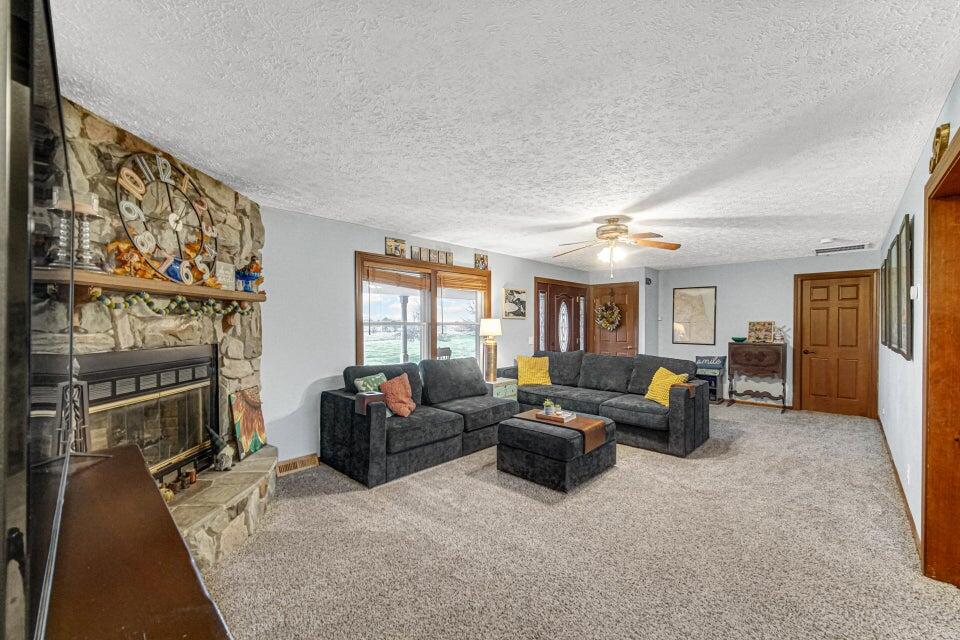 7960 East 173rd Avenue Hebron, IN 46341 - Photo 3 of 36 a living room with fireplace furniture and a flat screen tv