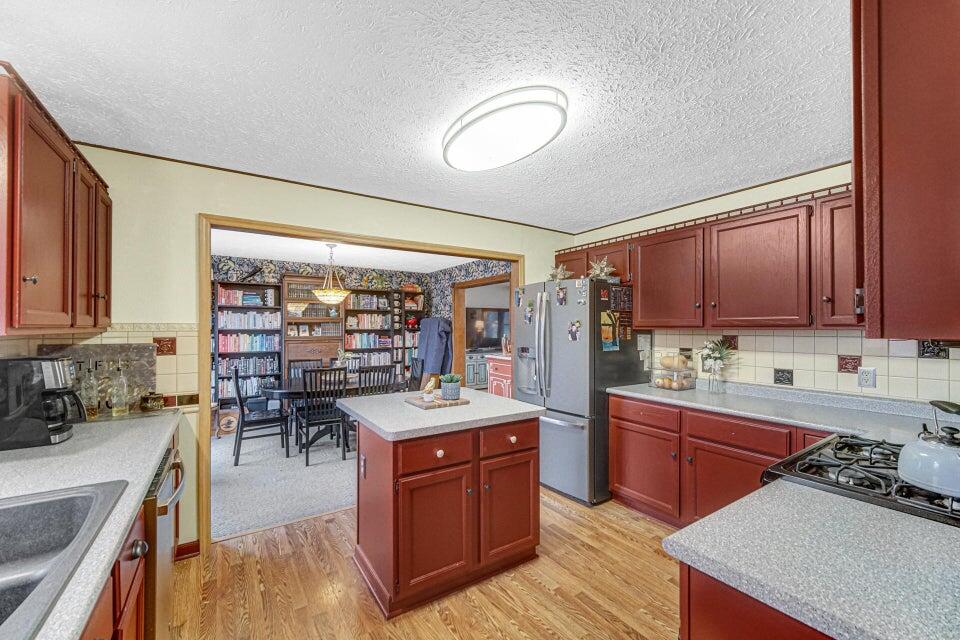 7960 East 173rd Avenue Hebron, IN 46341 - Photo 6 of 36 a kitchen with a sink stove and cabinets