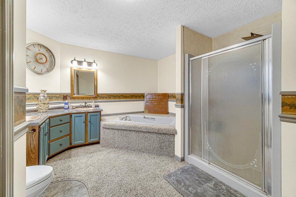 7960 East 173rd Avenue Hebron, IN 46341 - Photo 10 of 36 a bathroom with a granite countertop sink mirror vanity and bathtub