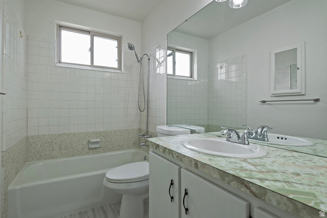 1722 Kimsbrough Road Sandy, UT 84092 - Photo 18 of 29 Bathroom featuring a full vanity with an integrated sink, a large mirror, and overhead lighting