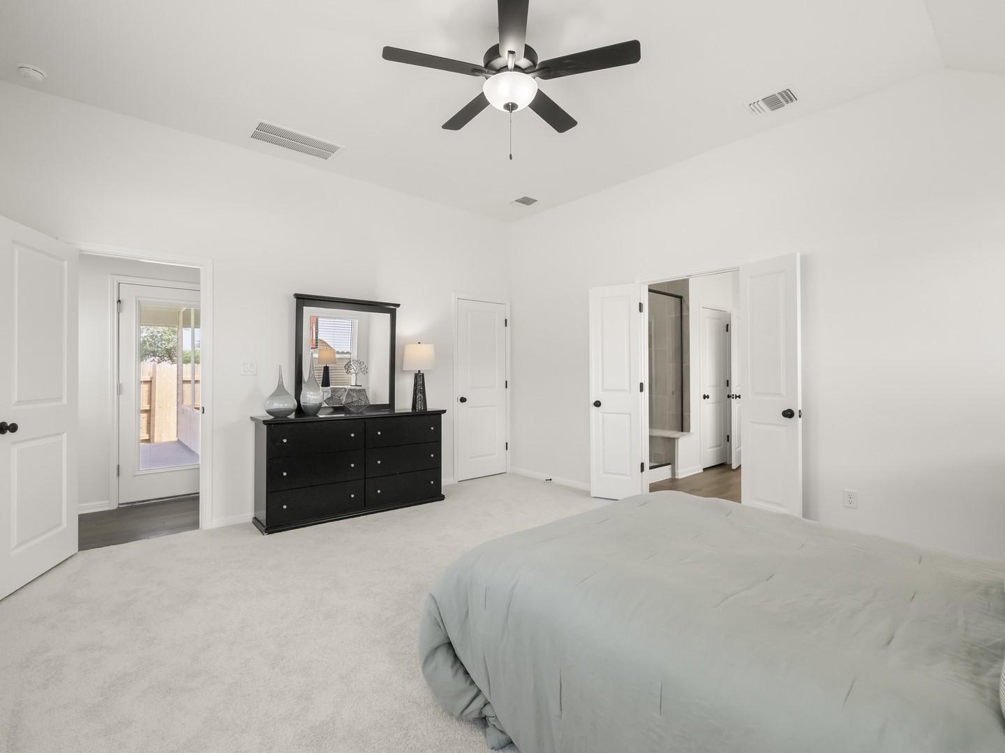 402 Judson Street Bertram, TX 78605 - Photo 13 of 27 a large bedroom with a bed and a chandelier