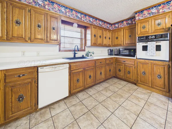 a kitchen with stainless steel appliances granite countertop a sink and cabinets