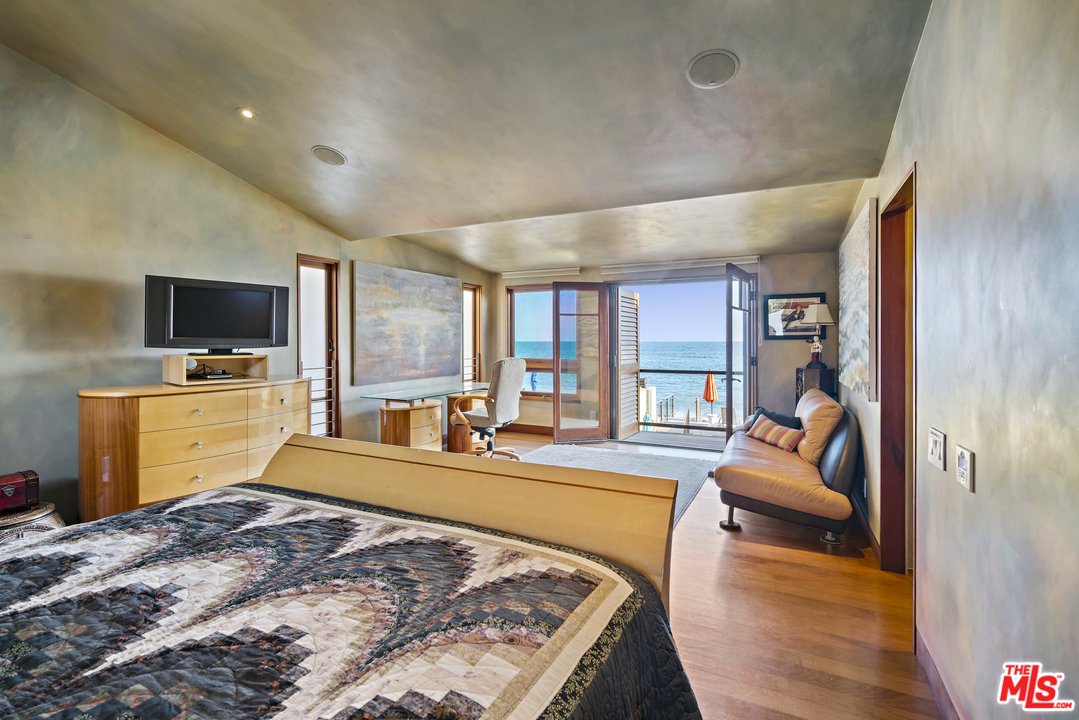 23746 Malibu Road Malibu, CA 90265 - Photo 13 of 46 a large bedroom with a bed and flat tv screen