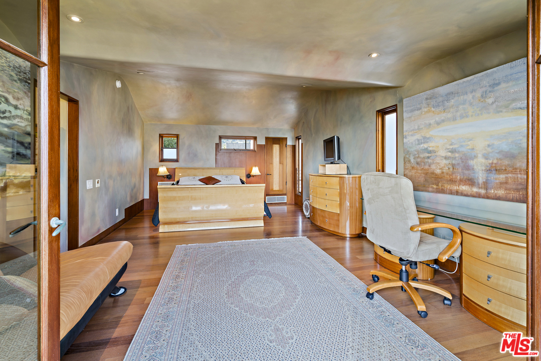 23746 Malibu Road Malibu, CA 90265 - Photo 14 of 46 a bedroom with furniture and a large window