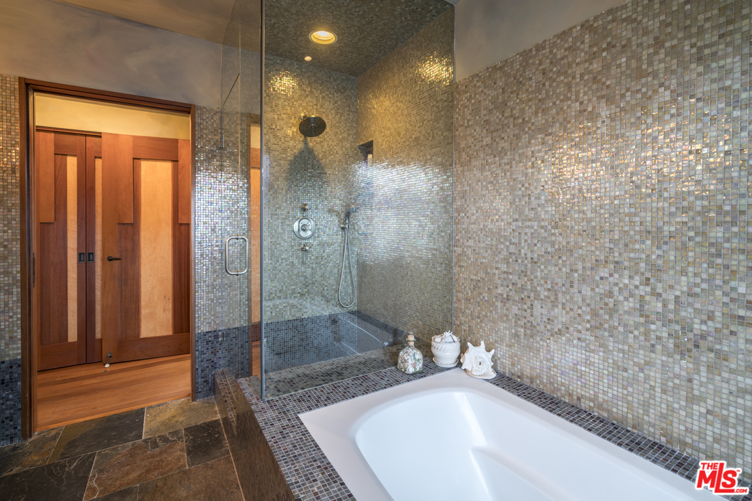 23746 Malibu Road Malibu, CA 90265 - Photo 15 of 46 a bathroom with a bathtub and a shower
